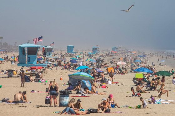 Image: People enjoy the beach amid the novel coronavirus pandemic in Huntington Beach, California on April 25, 2020.
