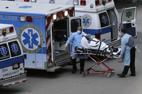 Image: Medical personnel remove a patient from an ambulance near an entrance to Massachusetts General Hospital