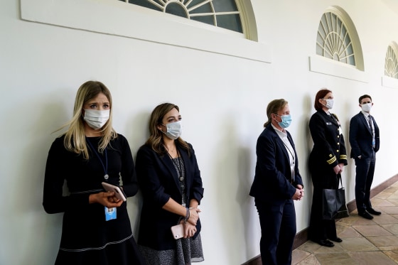 Image: Members of the White House staff and Secret Service along the West Wing colonnade on May 11, 2020.