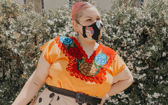 Designer Ashley Nell Tipton wears a Frida Kahlo themed mask.