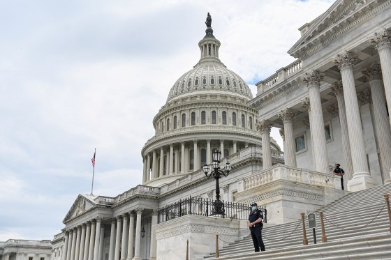Image: Police officers wearing face masks guard the U.S. Capitol Building in Washington