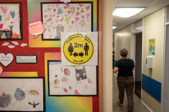 Image: Notices advising staff and pupils to maintain 2m of separation to create an environment safe from Coronavirus are displayed at Slaithwaite C of E Junior and Infant School in Slaithwaite, near Huddersfield, northern England