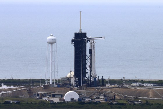 Image: A SpaceX Falcon 9 rocket and Crew Dragon spacecraft carrying NASA astronauts Douglas Hurley and Robert Behnken is seen before scheduled launch from NASA's Kennedy Space Center in Cape Canaveral
