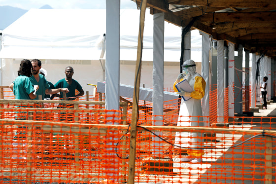 Image: FILE PHOTO: A health worker dressed in a protective suit talks to medical staff at the newly constructed MSF Ebola treatment centre in Goma