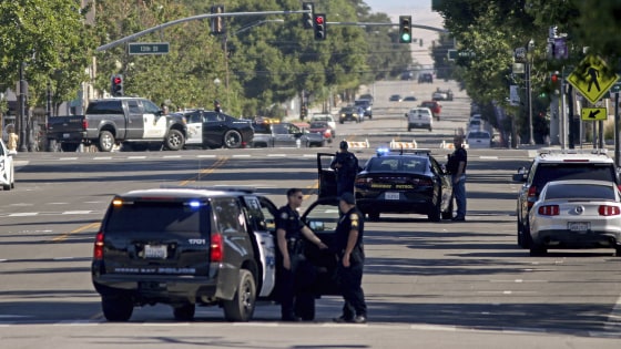 Image: Law enforcement personnel from several jurisdictions patrol Spring Street in downtown Paso Robles, Calif