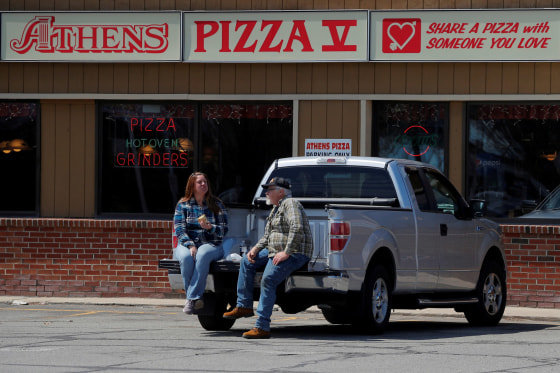 Image: Jim and Marilyn Ridel eat their take out lunch in the parking lot outside the restaurant amid the coronavirus disease (COVID-19) outbreak in Keene, New Hampshire