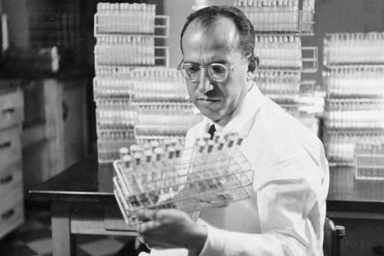 Dr. Jonas Salk, developer of the polio vaccine, holds a rack of test tubes in his lab in Pittsburgh on Oct. 7, 1954.