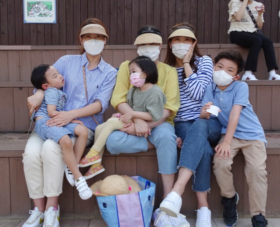 Image: Choi Woo-Jung (right) with her friends and their children at Everland amusement park in South Korea.