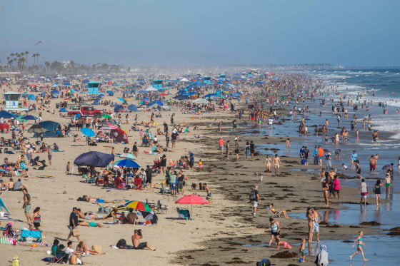 Image: People at the beach amid the coronavirus pandemic in Huntington Beach, Calif.