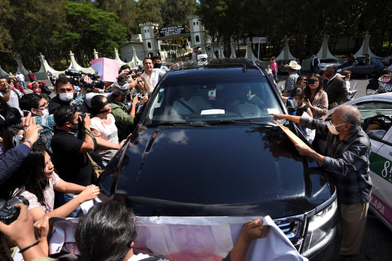 Image: Relatives of missing people surround the vehicle transporting Mexico's President Andres Manuel Lopez Obrador to ask him to stop and step down to talk to them, outside the 26-A Military Camp in El Lencero