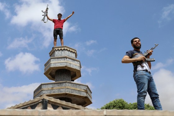 Image: Fighters loyal to Libya's internationally recognised government celebrate after regaining control over Tarhouna city