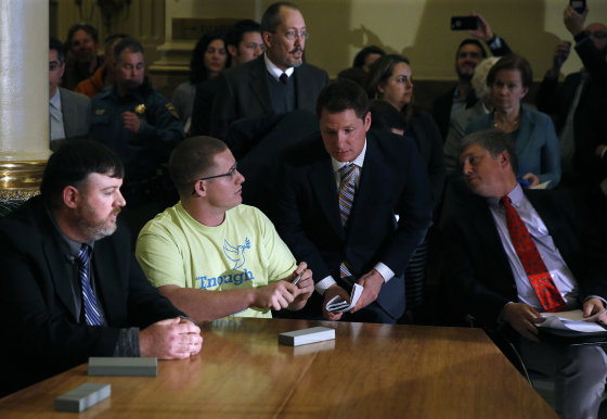 Image: Colorado elector Micheal Baca, second from left, talks with legal counsel after he was removed from the panel for voting for a different candidate than the one who won the popular vote