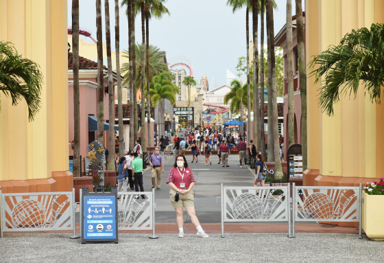 Park guests arrive at the Universal Studios theme park in Orlando, Fla.