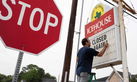 Image: A bar owner changes the marquee outside his bar to \"Closed Again\" at the West Alabama Ice House in Houston