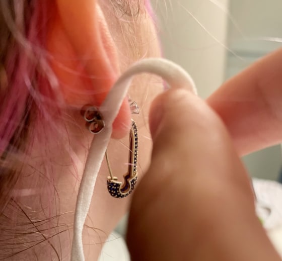 TikTok star says she had her face mask pierced to her ear