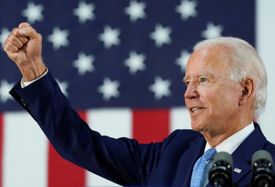 Image: Democratic presidential candidate Joe Biden thrusts his fist while answering questions from reporters during a campaign event in Wilmington,