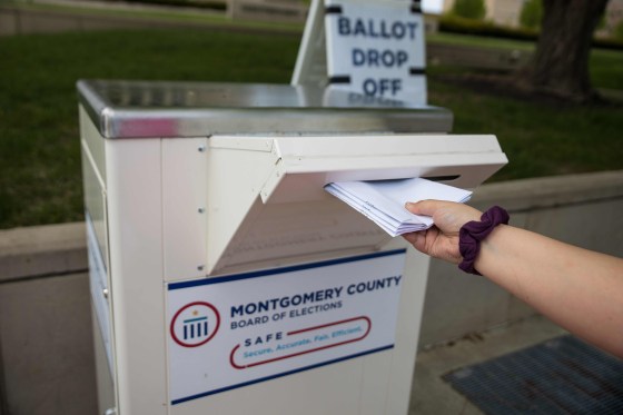Image: An Ohio voter drops off her ballot at the Board of Elections in Dayton, Ohio.