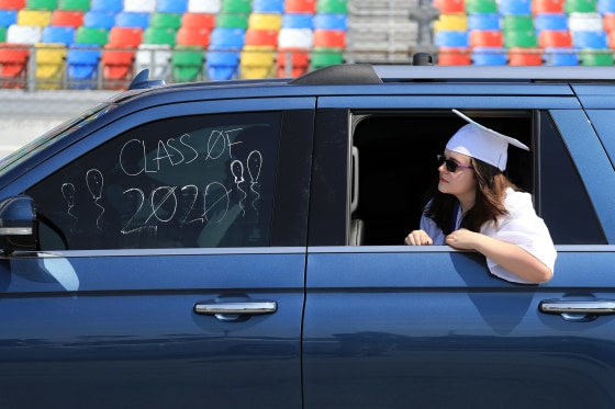 Image: Graduates of Matanzas High School receive their diplomas on the track in their cars at Daytona International Speedway