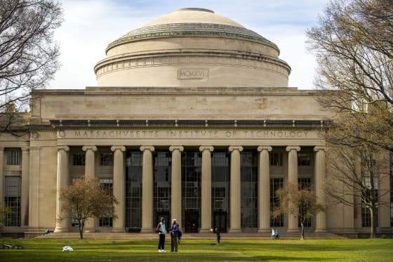 People stand on the Massachusetts Institute of Technology campus in Cambridge, Mass., on April 20, 2020.