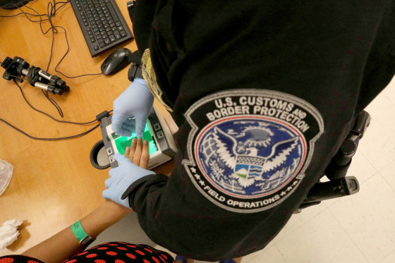 Image: A woman who is seeking asylum has her fingerprints taken by a U.S. Customs and Border patrol officer at a pedestrian port of entry from Mexico to the United States, in McAllen, Texas, May 10, 2017.