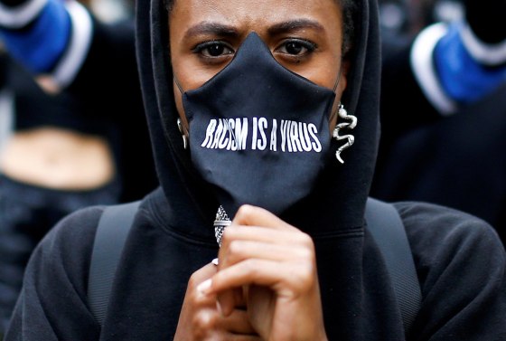 Image: A demonstrator wears a protective mask during a Black Lives Matter protest near Piccadilly Circus in London, Britain