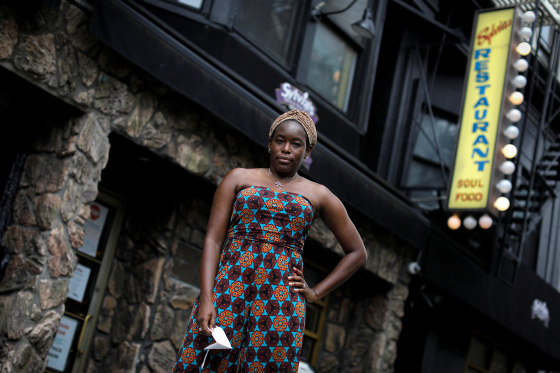 Image: Tren'ness Woods-Black, granddaughter of the late Sylvia Woods, poses outside Sylvia's Restaurant in Harlem in New York