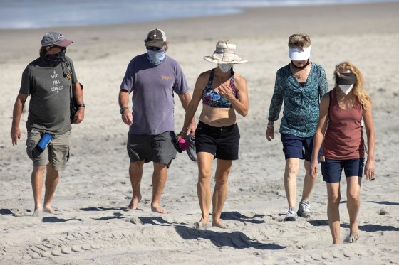 Image: People wear face masks at the beach as California reported its largest number of new coronavirus infections in a single day, during the outbreak of the coronavirus disease (COVID-19) in Del Mar