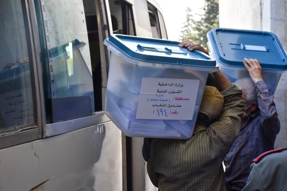 Image: Syrian men carry ballot boxes