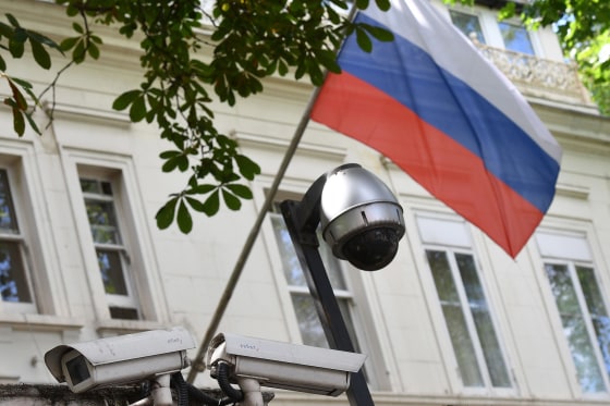 Image: A Russian flag flies by surveillance cameras at the entrance to the Russian consulate in London