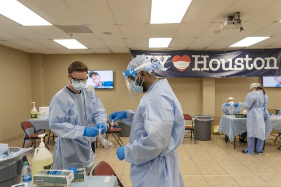Medical workers from New York handle test samples at a coronavirus test site in Houston on July 17, 2020.