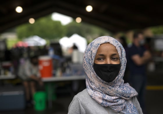 Image: Rep. Ilhan Omar (D-MN) speaks with local television journalists while campaigning at the Richfield Farmers Market