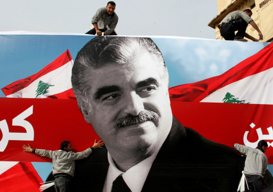 Image: FILE PHOTO: Workers prepare a giant poster depicting Lebanon's assassinated former prime minister Rafik al-Hariri, in downtown Beirut