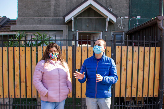 Cristabel L?pez, 43, and her son, Felipe, 26, in front of their home in a Santiago suburb.
