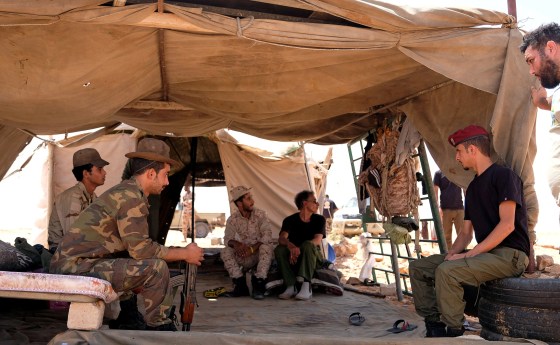 Image: Members of the Libyan National Army (LNA) commanded by Khalifa Haftar sit inside a tent at one of their sites in west of Sirte