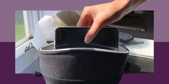 hand putting smartphone in uv light sanitizing bag