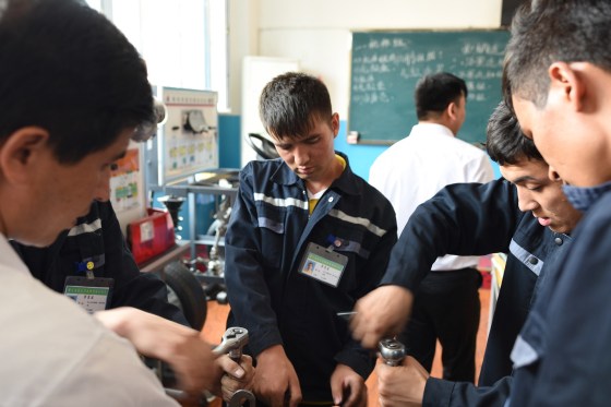 Image: Uighur people learn practical skills at an education camp in Xinjiang, China.