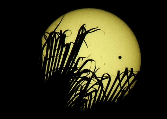 The planet Venus (black spot on the righ