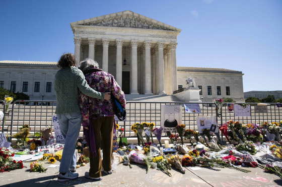 Image: Women embrace at a makeshift memorial for late Supreme Court Justice Ruth Bader Ginsburg on the steps of the United States Supreme Court
