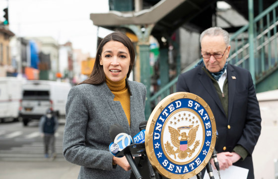 Image: Democratic Congresswoman from New York Alexandria Ocasio-Cortez speaks as Senate Minority Leader Chuck Schumer listens during a press conference in the Corona neighborhood of Queens.