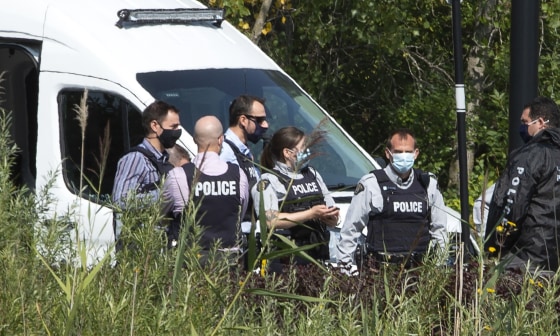 Image: Royal Canadian Mounted Police officers gather outside an apartment complex during a raid in connection with the mailing of ricin to President Trump, Monday, September 21, 2020 in St-Hubert, Quebec.