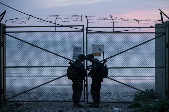 Image: South Korean soldiers lock the entrance to a beach on Yeonpyeong island, near the 'northern limit line' sea boundary with North Korea.