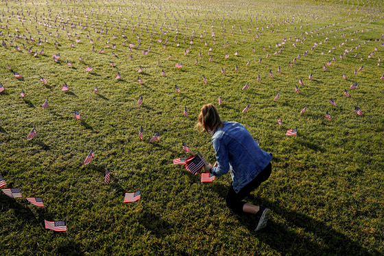 Image: American flags representing 200,000 lives lost due to coronavirus are placed on National Mall in Washington