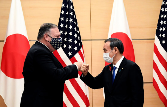 Image: Japan's Prime Minister Yoshihide Suga and Secretary of State Mike Pompeo (L) bump fists as they meet at the prime minister's office in Tokyo