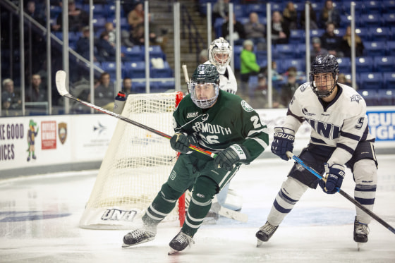 New Hampshire defenseman Will MacKinnon jockeys for position with Dartmouth forward Jeff Losurdo during game on Nov. 2, 2019.