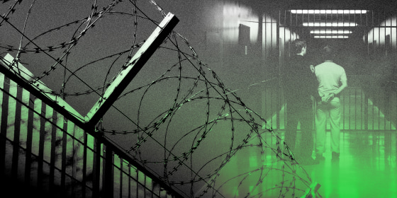 Image: Barbed wire fence and a prisoner being walked through <a href=