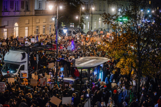Image: People hold banners and dance as they participate in a national strike during the seventh day of protests against the Constitutional Court ruling on tightening the abortion law on Oct. 28, 2020 in Warsaw, Poland.