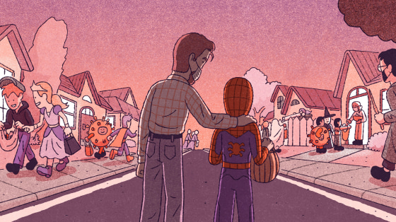 Image: A father wearing a mask holds the shoulders of his son, dressed as Spider-Man, as other children trick-or-treat on a street.