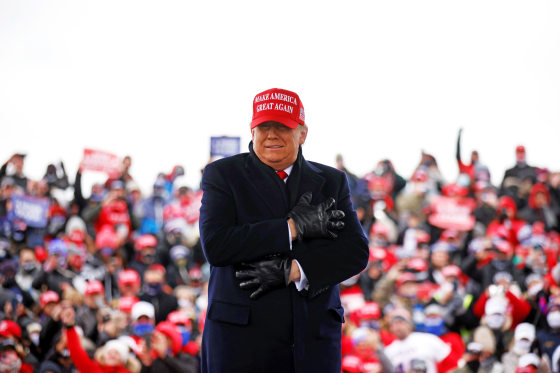 Image: U.S. President Donald Trump reacts to cold weather and wind during a campaign rally at Michigan Sports Stars Park in Washington