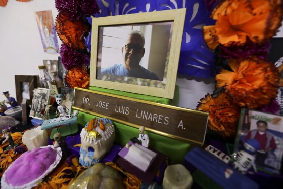 Image: A portrait of Dr. Jose Luis Linares who died from symptoms related to COVID-19, placed on a Day of the Dead altar made by his wife Rosario Martinez at their home in Mexico City,