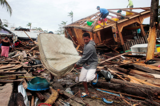 Image: Residents recover a mattress from the debris of their house damaged by the passing of Hurricane Iota, in Puerto Cabezas